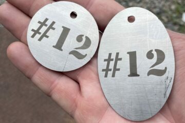 naptag alternative: sustainable stainless steel tags reading #12, one circular and one ovular
